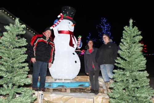 Greg Ducharme, Rhonda Lemke and Stephanie Lemke with the new 7-foot illuminated snowmen welcoming visitors to Riverhill Farm this season. Photo/Craig Bakay